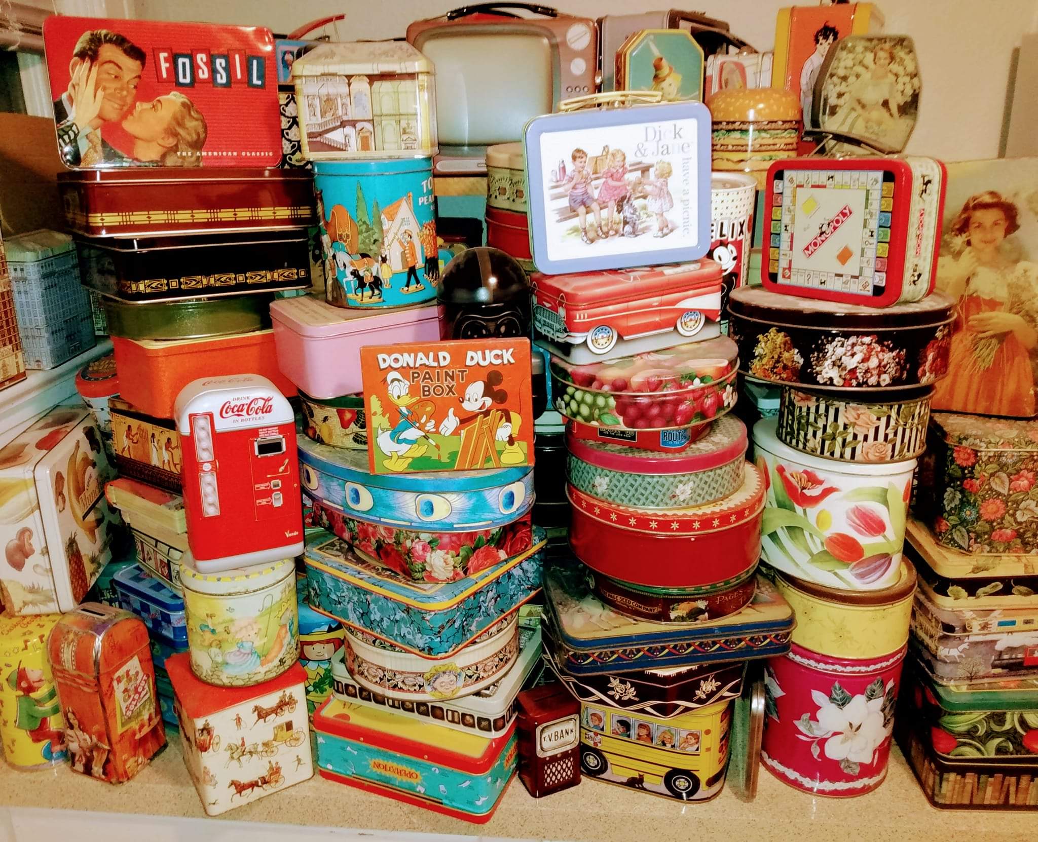 A large pile of tins

Description automatically generated